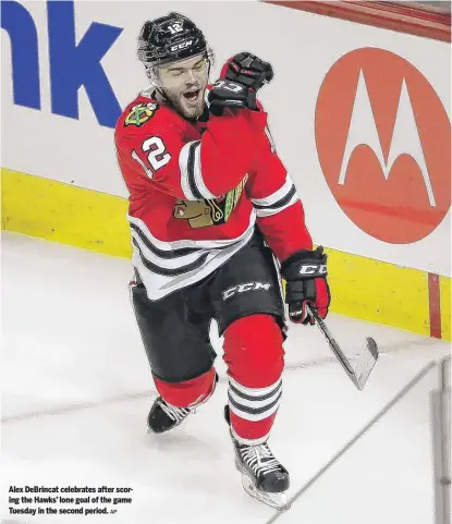  ?? AP ?? Alex DeBrincat celebrates after scoring the Hawks’ lone goal of the game Tuesday in the second period.