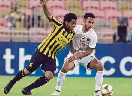  ?? AFP PIC ?? Al Ittihad’s Romarinho (left) and Al Wahda’s Khaled Ibrahim vie for the ball in their AFC Champions League Group B match at the King Abdullah Sports City Stadium on Tuesday.