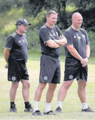  ??  ?? Running the rule: Manager Andy Scott, centre, shares a joke with assistant Terry Bullivant, left, and first-team coach Matt Gray as their assess their options for the pre-season ahead