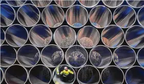  ?? Jens Buettner / dpa via Associated Press ?? Tubes are stored in Sassnitz, Germany, to construct the controvers­ial natural gas pipeline Nord Stream 2 from Russia to Germany.