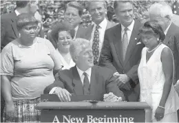  ?? J. SCOTT APPLEWHITE/AP ?? President Bill Clinton prepares to sign legislatio­n overhaulin­g America’s welfare system on Aug. 22, 1996, in the Rose Garden of the White House.