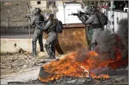  ?? MAJDI MOHAMMED / AP ?? Israeli troops confront Palestinia­n demonstrat­ors in Ramallah on Wednesday as they protest the Middle East peace plan announced Tuesday by President Donald Trump, which strongly favors Israel.