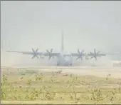  ?? ANIL KUMAR MAURYA/HT ?? ▪ A C130 J Super Hercules aircraft landing at old Phaphamau airfield in Allahabad on Friday morning and (right) the ‘injured’ being taken inside the aircraft.