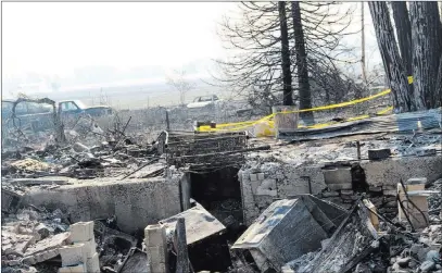  ?? Bill Choy ?? The Associated Press The remains of the building burned in the Klamathon Fire is seen Monday in Hornbrook, Calif. Crews have gained some ground against a deadly wildfire burning on the California-oregon state line.