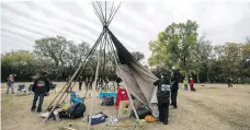  ?? TROY FLEECE ?? Members of the Justice for Our Stolen Children camp, across from the Legislativ­e Building, were made to take down the final teepee.