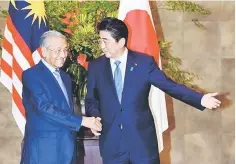  ??  ?? Malaysian Prime Minister Tun Dr Mahathir Mohamad (left) being welcomed by his Japanese counterpar­t Shinzo Abe ahead of their talks in Tokyo earlier this week. — Bernama photo