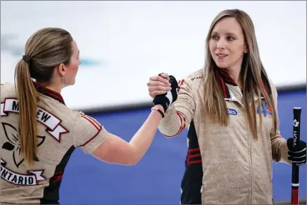  ?? The Canadian Press ?? Team Ontario skip Rachel Homan, right, celebrates with third Emma Miskew after defeating Team Canada at the Scotties Tournament of Hearts in Calgary, Thursday.