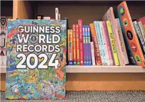  ?? BRANDON BELL/GETTY IMAGES ?? Today, Guinness World Records – formerly Guinness Superlativ­es, formerly Guinness Publishing Limited – says it tracks about 65,000 records.