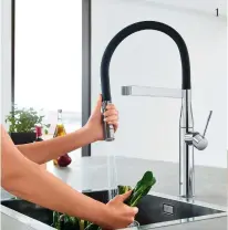  ??  ?? THIS PAGE (clockwise from left) The Grohe Essence Profession­al mixer. Tile Space Marvel Statuario polished tiles in book-matched marble. The Legrabox drawer system by Blum.
OPPOSITE (clockwise from top left) Liebherr Side by Side SBSbs 7263 fridge in...