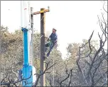  ?? STAFF FILE PHOTO ?? PG&E crews repair power lines in October in a Napa neighborho­od devastated by the Atlas Peak fire.