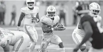 ?? JOHN MCCALL/SOUTH FLORIDA SUN SENTINEL ?? Dolphins running back Myles Gaskin runs for yards against the Giants during the second half at Hard Rock Stadium in Miami Gardens. Gaskin and Salvon Ahmed are returning from the reserve/COVID-19 list.