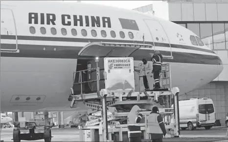  ?? XINHUA ?? Ground staff at Minsk, Belarus, unload Sinopharm’s COVID-19 vaccines, which were donated by the Chinese government, on Feb 19.