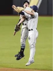  ?? ERIC GAY AP ?? Rays’ Willy Adames and Brandon Lowe (front) celebrate their win in Game 2, led by Lowe’s two home runs.