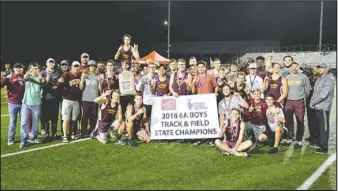  ?? Submitted photos ?? BANNER DAY: (Top) Members of the Lady Wolves track and field team display their Class 6A state track and field championsh­ip banner Thursday in Russellvil­le. (Bottom) Members of the Lake Hamilton boys’ track and field team display their Class 6A state...