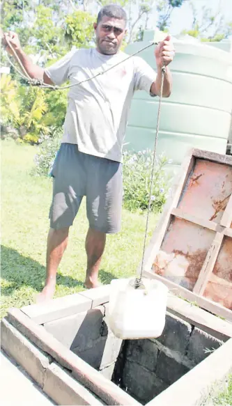  ?? Picture: ADRA Fiji ?? Ekubu Villager draws water from the well.