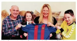  ??  ?? It’s a keeper Lendrums from the left, dad Tom, sister Chloe, 7, mum Caroline and young Khalan with his prized Barcelona signed shirt