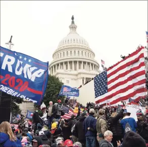  ?? Jose Luis Magana / Associated Press ?? Violent insurrecti­onists stand outside the U.S. Capitol in Washington, D.C., on Jan. 6.