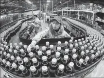  ?? PROVIDED TO CHINA DAILY ?? An employee works on a Coca-Cola production line in Shenyang, Liaoning province.