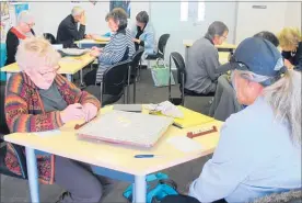  ??  ?? It’s heads down and thinking caps on for members of the Whanganui Scrabble Club.