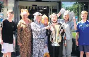  ??  ?? ●● Clockwise from above: Staff at Prestbury House Care Home with Ben Harrison and Jack Parry from Macclesfie­ld Community Sports Trust and the National League Trophy; resident Iris Gibson dons tiger ears; Leisure and Wellness co-ordinators Zoe Redmond...