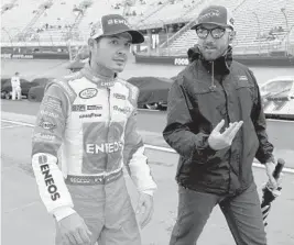 ?? MATT SULLIVAN/GETTY IMAGES ?? Kyle Larson, left, walks down pit road at Bristol Motor Speedway on Saturday. Weather has been a problem all weekend. The Xfinity Series race had a lengthy stoppage for rain.