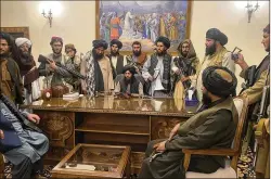  ?? ZABI KARIMI/ASSOCIATED PRESS ?? Taliban fighters take control of the presidenti­al palace Aug. 15 in Kabul, Afghanista­n, after Afghan President Ashraf Ghani fled the country.