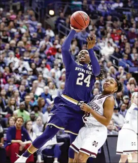  ?? ANDY LYONS / GETTY IMAGES ?? Arike Ogunbowale (left, attempting a shot earlier in the game) hit the game-winner for Notre Dame again Sunday.