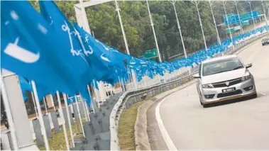  ??  ?? ... Election fever is already in the air going by the BN banners lining a road in Putrajaya.