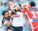  ?? Photo / Getty Images ?? Tyson Frizell is hit by Issac Luke (left) and Sam Lisone.