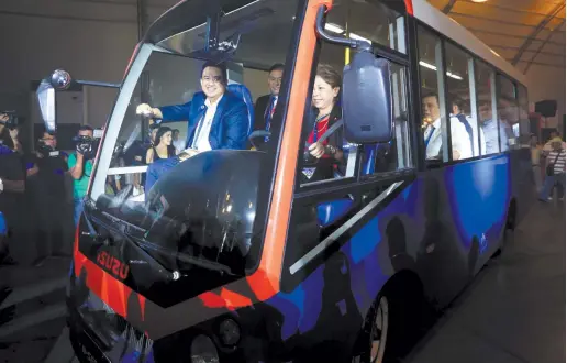  ??  ?? ATTY. AILEEN LIZADA, LTFRB Board Member, with DoTr Undersecre­tary for Road Thomas Orbos test drive an electric minibus during the Public Transport Modernizat­ion Expo held last April at Philippine Internatio­nal Convention Center in Pasay City.
