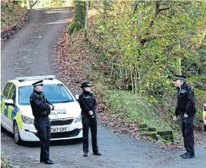  ?? Pictures: PA, SWNS ?? Police at the scene of the fire yesterday in Llangammar­ch Wells which left the house a burnt- out shell. A father and four children are believed to have died