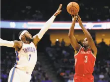  ?? Sue Ogrocki / Associated Press ?? Old faces in new places: Houston guard Chris Paul shoots against the Thunder’s Carmelo Anthony in the preseason.