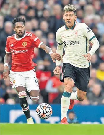  ?? ?? Dominant: Roberto Firmino (right) gets ready to show Fred a clean pair of heels at Old Trafford