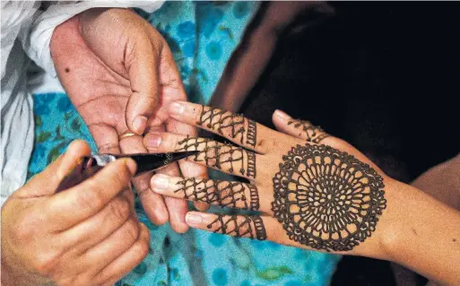  ?? PRAKASH MATHEMA AFP VIA GETTY IMAGES FILE PHOTO ?? The main protagonis­t in “The Henna Artist,” by Alka Joshi, uses her artistic skills to enter the boudoirs of the wealthy and sift through their gossip.