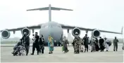  ??  ?? People from Afghanista­n arrive by special repatriati­on IAF flight at Hindan Air Force Station, in Ghaziabad