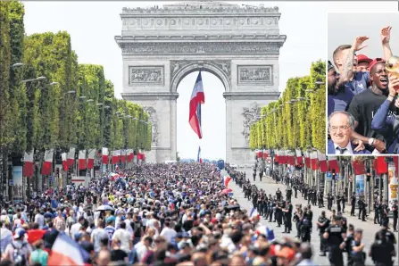  ??  ?? Supporters gather on the Champs-Elysees avenue near the Arch of Triumph (Arc de Triomphe) in Paris on Monday as they wait for the arrival of the French team for celebratio­ns.