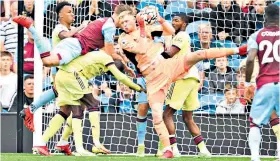  ??  ?? Dominant: Arsenal keeper Aaron Ramsdale takes command to relieve pressure at Turf Moor