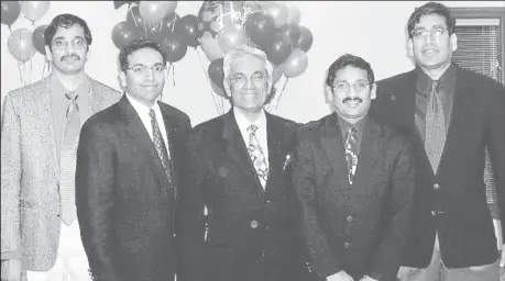  ?? ?? Dharamdeo Sawh (centre) with his sons, all Guyana scholars and specialist­s in the medical field