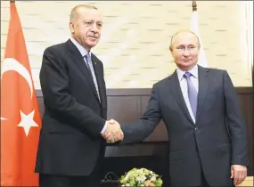  ?? Sergei Chirikov / Associated Press ?? Russian President Vladimir Putin, right, and Turkish President Recep Tayyip Erdogan pose during their meeting in the Black Sea resort of Sochi, Russia.