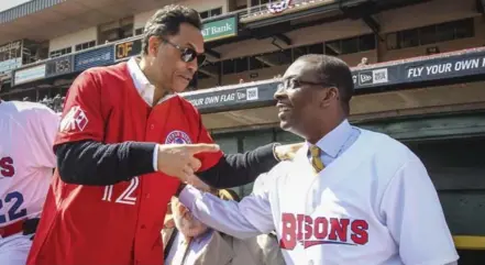  ?? DAVID COOPER/TORONTO STAR ?? Hall of Famer Roberto Alomar, left, talks with Buffalo Mayor Byron W. Brown before they threw out the ceremonial first pitches on opening day for the Bisons.