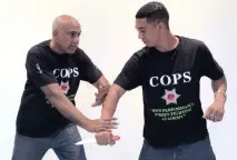  ??  ?? Robby Mahabeer and Joshua Nichol do a self-defence demonstrat­ion.