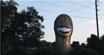  ??  ?? An giant peanut, made in Indiana as a tribute to Jimmy Carter, stands outside a convenienc­e store in Plains, Ga.