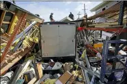  ?? DAVID J. PHILLIP — THE ASSOCIATED PRESS ?? Jacob Hodges, right, and his brother Jeremy Hodges work Aug. 30to clear debris from their storage unit which was destroyed by Hurricane Ida in Houma, La.