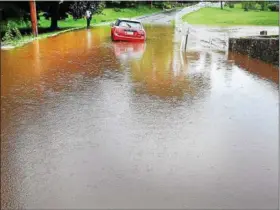  ?? TOM KELLY III — FOR DIGITAL FIRST MEDIA ?? This unfortunat­e motorist drove a Cooper Mini into high water on Ellis Woods Road in East Coventry Aug. 13 and was awaiting a tow.