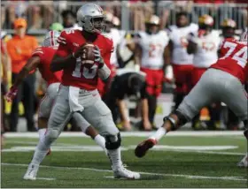  ?? JAY LAPRETE — THE ASSOCIATED PRESS ?? Ohio State quarterbac­k J.T. Barrett looks for receiver against Maryland earlier this season.