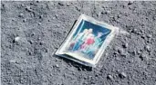  ??  ?? A photo of astronaut Charles Duke’s family, wife Dorothy Meade Claiborne and two sons, that he left on the moon.