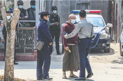  ?? STR / AFP VIA GETTY IMAGES ?? Police escort Buddhist abbot Myawaddy Mingyi Sayadaw at a court compound in Mandalay, Myanmar, on Wednesday following his arrest as a longtime critic of the country's military.