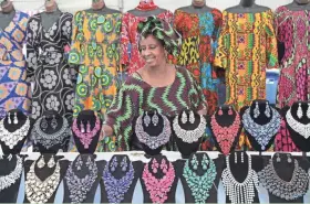  ?? MICHAEL SEARS/MILWAUKEE JOURNAL SENTINEL ?? Touba Fall of Touba Africa Art sets out items to sell during a previous Bronzevill­e Week Celebratio­n. This year‘s celebratio­n of the historical­ly African American neighborho­od will take place Aug. 7 through Aug. 14.