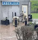  ?? ?? Firefighte­rs tackle the flood.