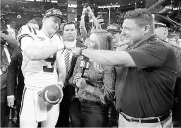  ?? /JOHN BAZEMORE/AP ?? LSU quarterbac­k Joe Burrow and Tigers coach Ed Orgeron celebrate after winning the Southeaste­rn Conference championsh­ip Saturday. LSU was among the right choices to make an exciting playoff lineup this year.